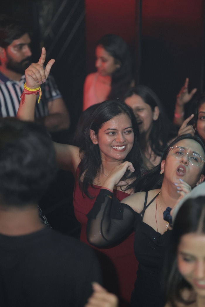 DJ VIC with stage lighting at a high-energy club night